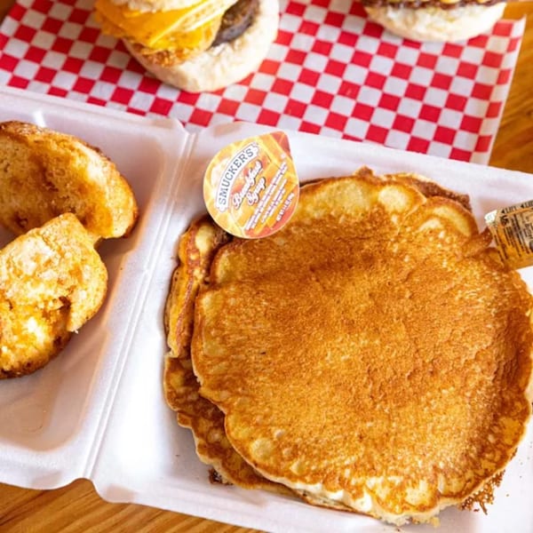 Pancakes, biscuits, and breakfast sandwiches in a to-go container from Biscuit Bros.